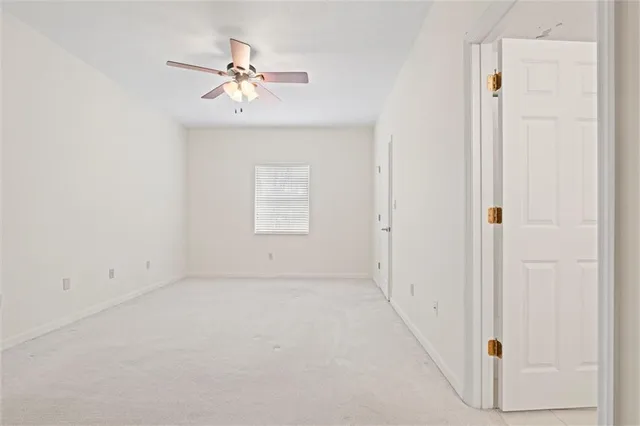a white toilet sitting next to a shower