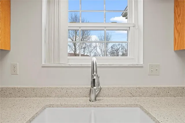 a kitchen with stainless steel appliances granite countertop a sink a microwave cabinets and wooden floor