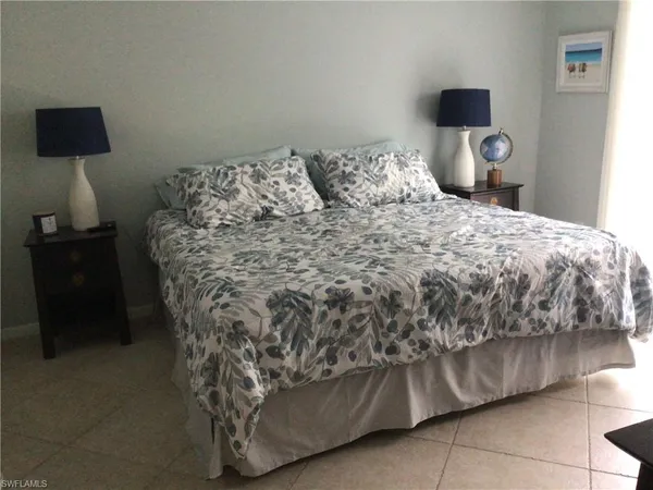 a bedroom with a bed and a lamp