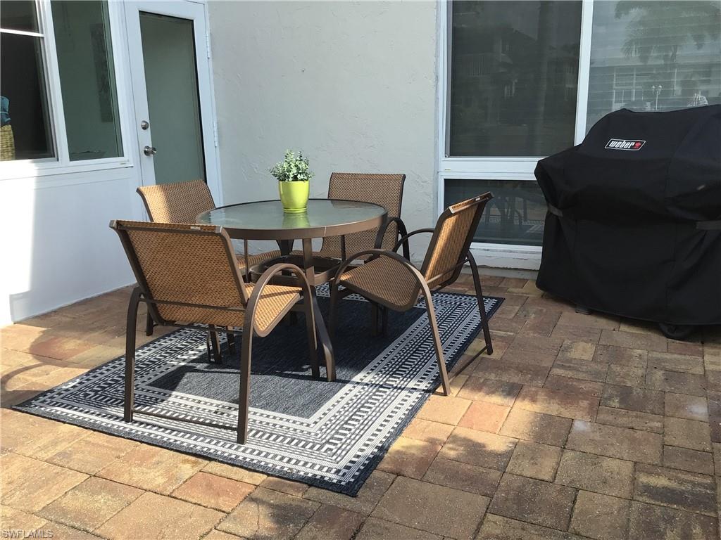 195 Peppermint Lane, Unit 881 Naples, FL 34112 - Photo 18 of 35 a view of a outdoor seating area with furniture