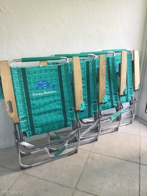 195 Peppermint Lane, Unit 881 Naples, FL 34112 - Photo 19 of 35 a living room with a couch and a large window