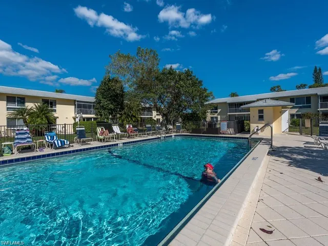 a sign that is sitting in front of flowers