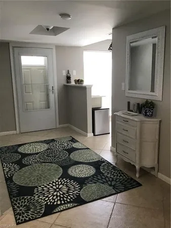 a bathroom with a bathtub sink and mirror