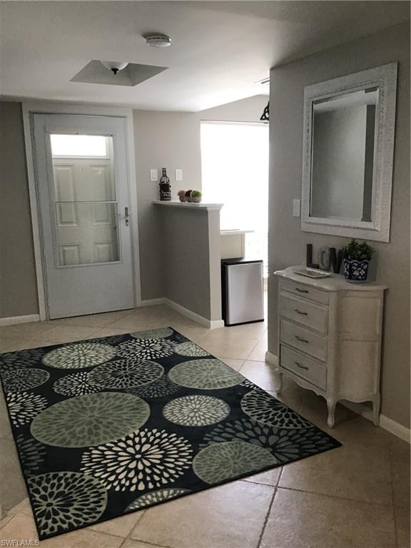 195 Peppermint Lane, Unit 881 Naples, FL 34112 - Photo 2 of 35 a bathroom with a bathtub sink and mirror