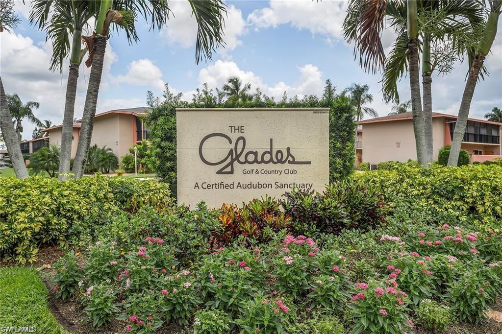 195 Peppermint Lane, Unit 881 Naples, FL 34112 - Photo 21 of 35 a sign that is sitting in front of flowers