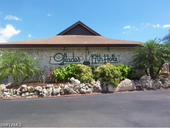 195 Peppermint Lane, Unit 881 Naples, FL 34112 - Photo 24 of 35 a front view of a house with a yard and garage