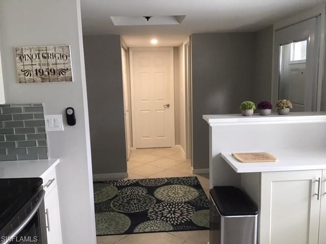 195 Peppermint Lane, Unit 881 Naples, FL 34112 - Photo 3 of 35 a bathroom with a sink and a mirror