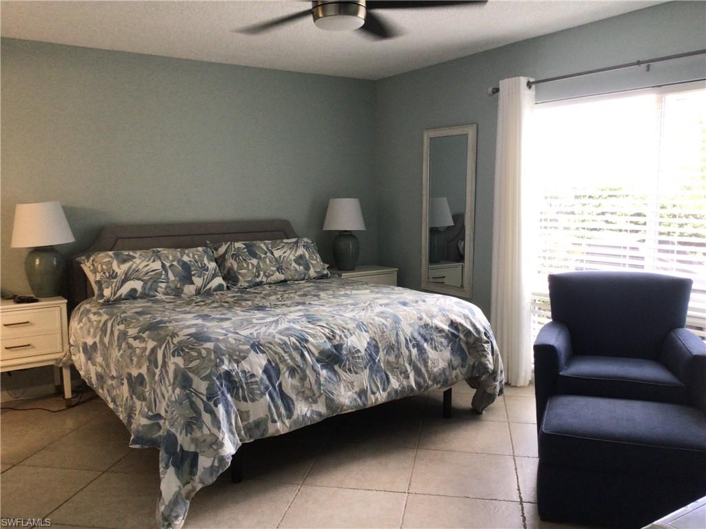 195 Peppermint Lane, Unit 881 Naples, FL 34112 - Photo 8 of 35 a bedroom with a bed and window
