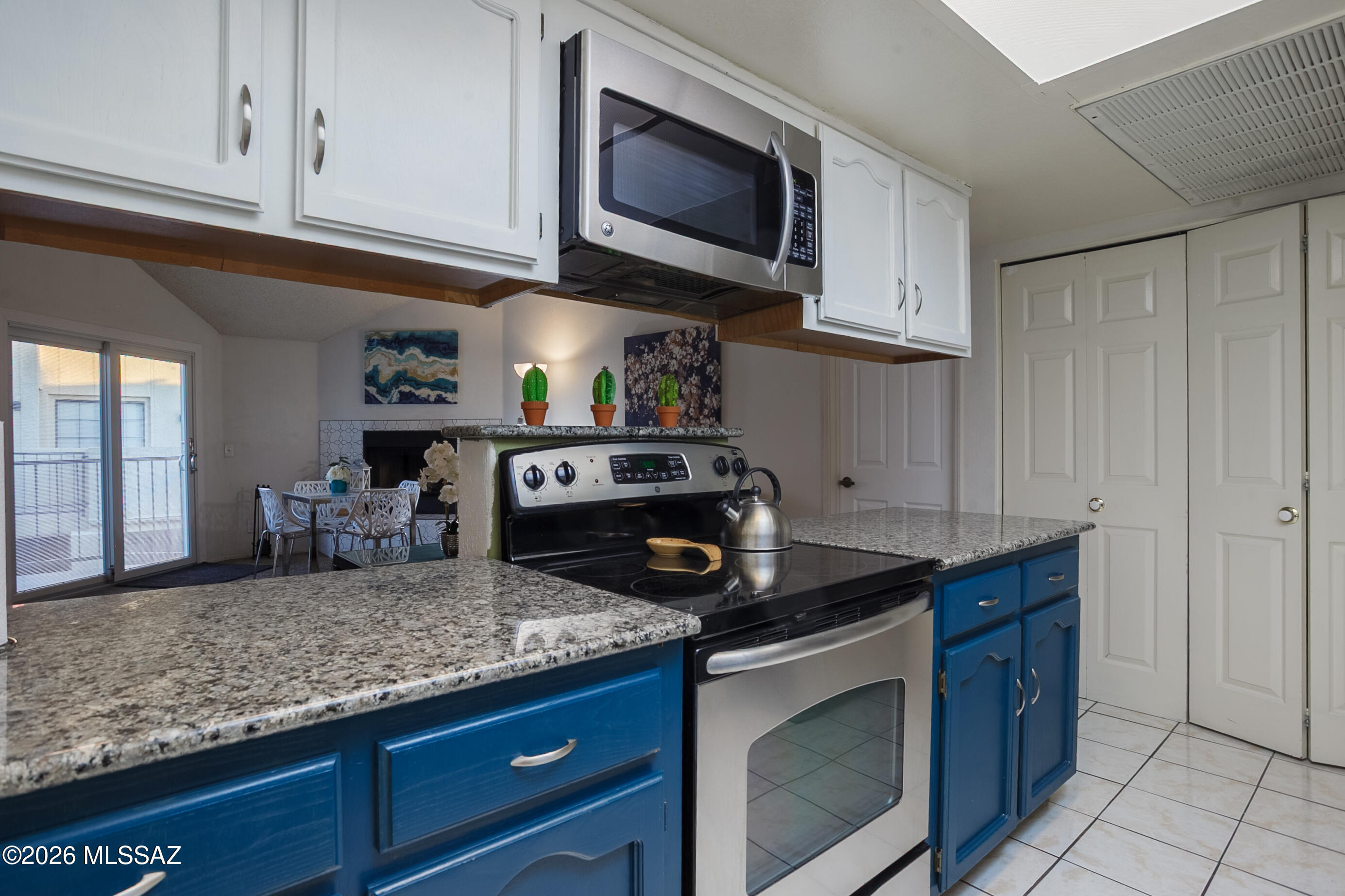 1200 East River Road, Unit B27 Tucson, AZ 85718 - Photo 14 of 40 a kitchen with granite countertop a stove sink and cabinets