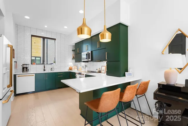 a kitchen with a sink cabinets and wooden floor