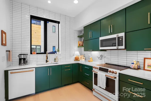 a kitchen with stainless steel appliances a sink stove and microwave