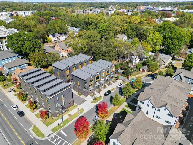 an aerial view of a residential houses with outdoor space
