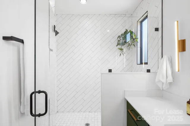a white vase with white flowers sitting on a shelf
