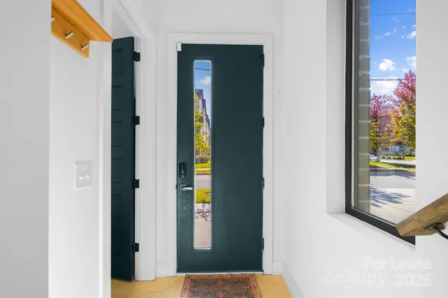 a view of a bathroom that has a door and a window