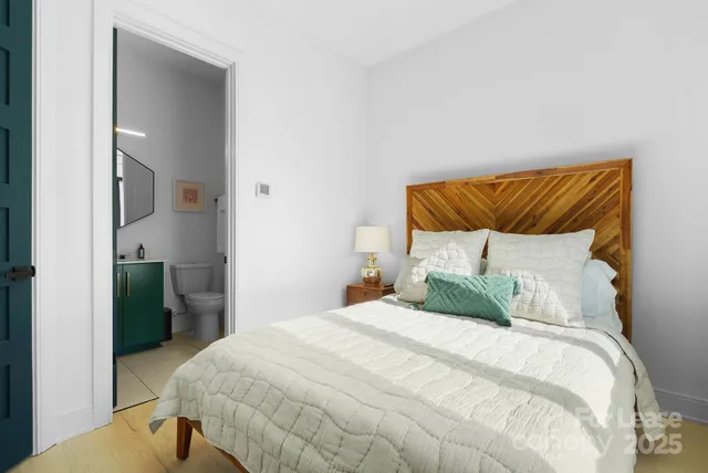 a bedroom with a bed and a mirror