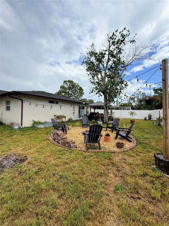 1330 Georgetowne Circle Sarasota, FL 34232 - Photo 43 of 46 a view of a swimming pool with lawn chairs and potted plants