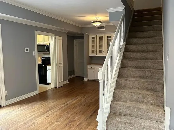 a view of entryway and hall with wooden floor