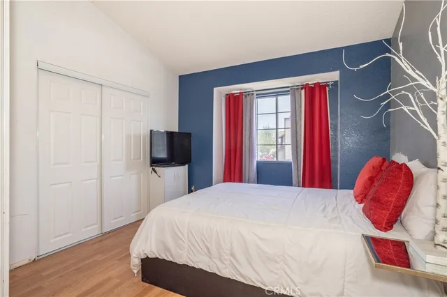 a bedroom with a bed and a window