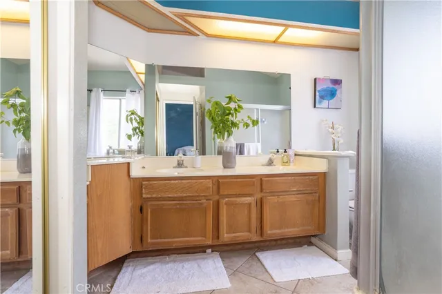 a bathroom with a double vanity sink and a mirror