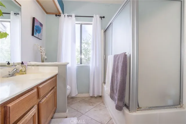 a bathroom with a sink a mirror and a shower