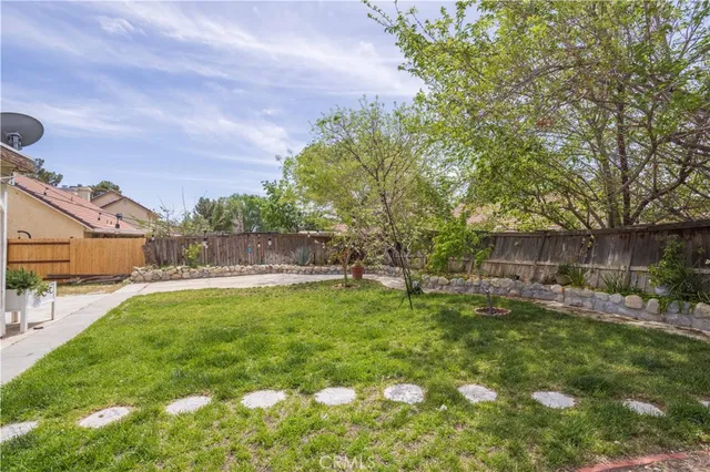 a backyard of a house with yard fire pit and outdoor seating