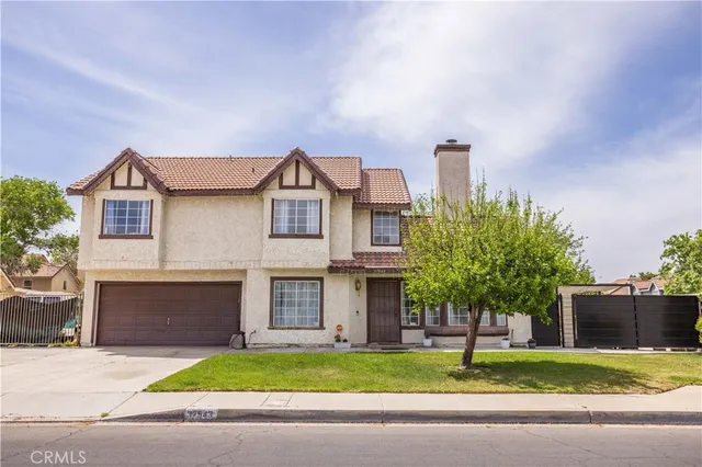 a front view of a house with a garden and plants