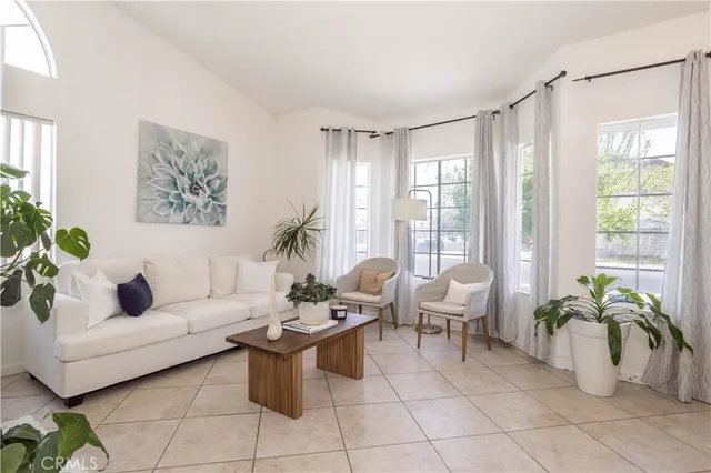 a living room with furniture and a potted plant