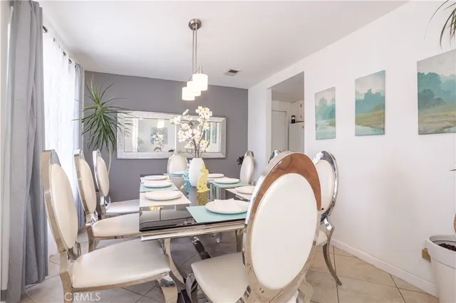 a dining room with furniture a chandelier and window