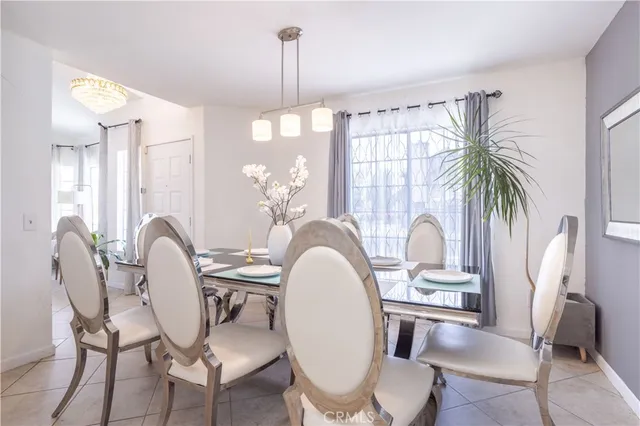 a dining room with furniture a chandelier and window