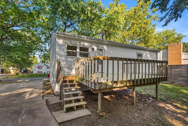 a view of a chairs and table in the backyard