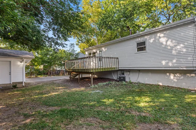 a backyard of a house with table and chairs