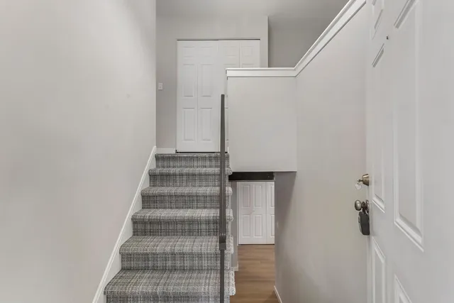 a view of staircase with white walls