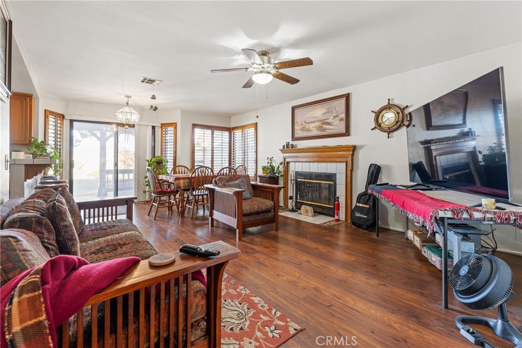 2323 Golden Lancaster, CA 93536 - Photo 11 of 34 a living room with furniture a fireplace and a chandelier