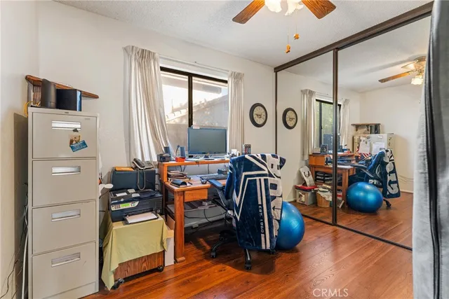 a view of a workspace with furniture and a window
