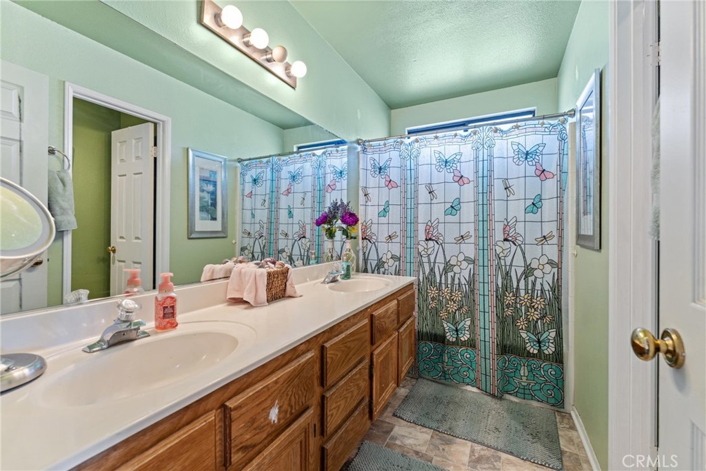 2323 Golden Lancaster, CA 93536 - Photo 18 of 34 a bathroom with a double vanity sink mirror and shower