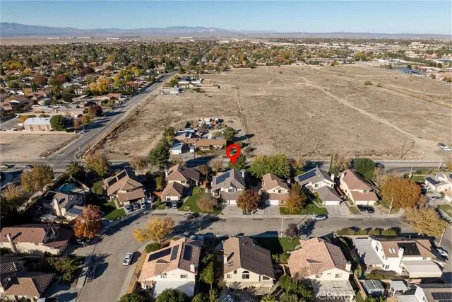 an aerial view of multiple houses with yard