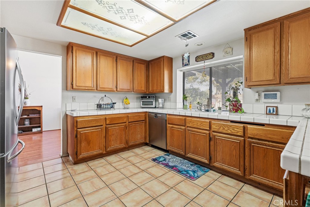 2323 Golden Lancaster, CA 93536 - Photo 9 of 34 a kitchen with stainless steel appliances granite countertop a sink and cabinets