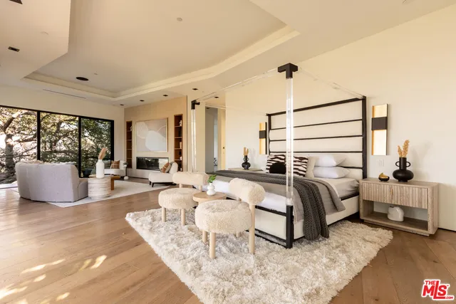 a living room with furniture floor to ceiling window and a flat screen tv