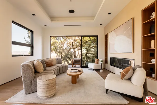 a living room with furniture a rug and a large window