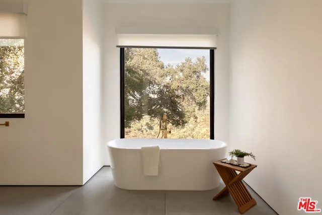 a bedroom with a large bed and a large window