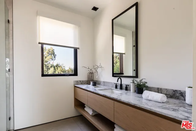 a bedroom with bed and window