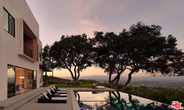 a view of a house with swimming pool and sitting area