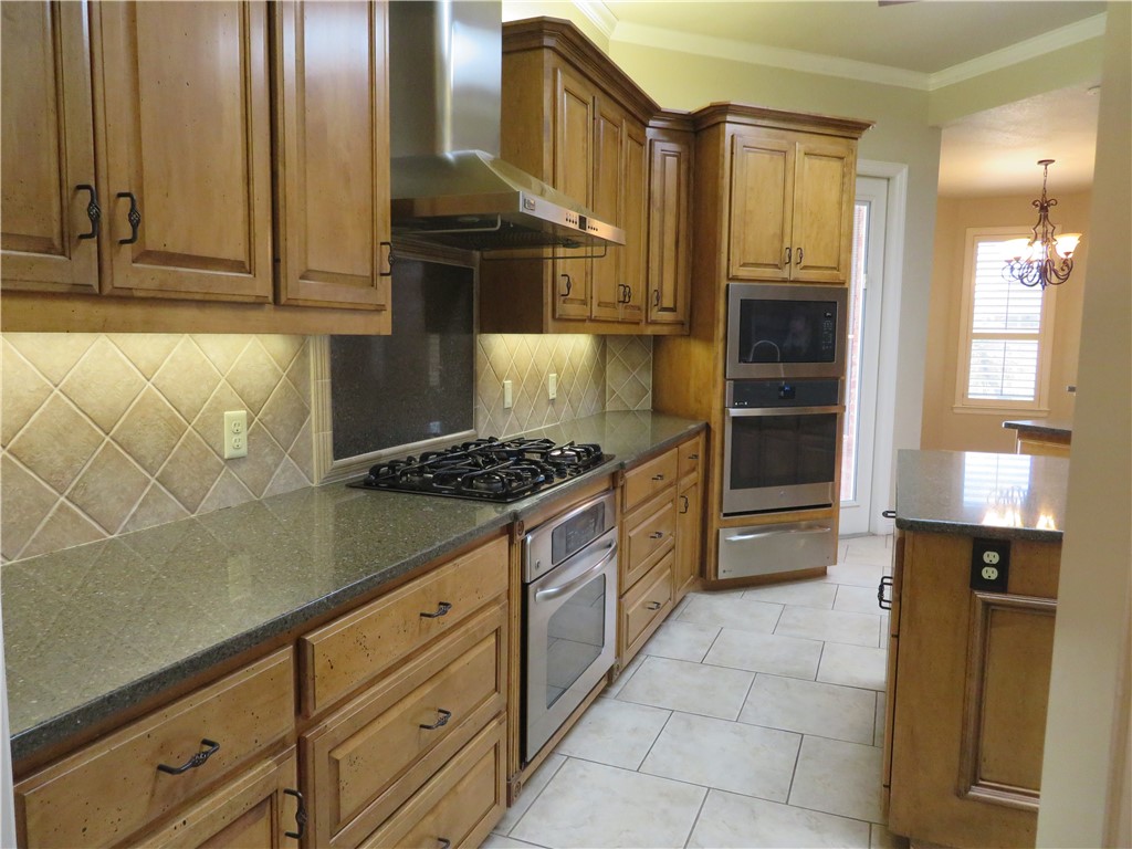 5803 South Oso Parkway Corpus Christi, TX 78414 - Photo 15 of 39 a kitchen with stainless steel appliances granite countertop a stove and a refrigerator