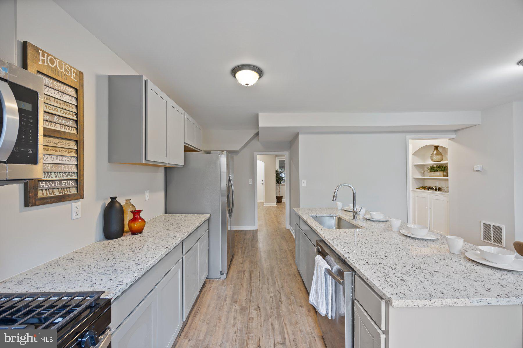 1526 Sheffield Road Baltimore, MD 21218 - Photo 6 of 20 a kitchen with stainless steel appliances granite countertop a sink stove and refrigerator