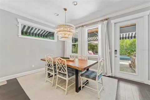 a dining room with furniture and a kitchen view