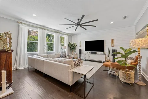 a view of a hallway with bathroom and wooden floor