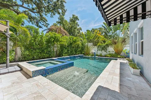 a view of a backyard with sitting area