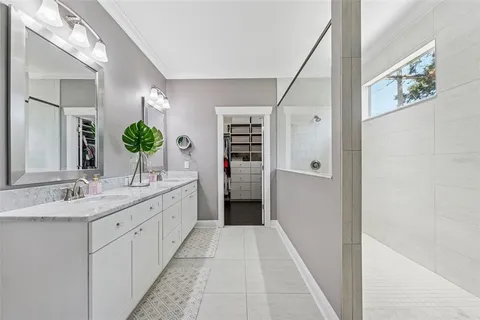 a view of walk in closet with clothes