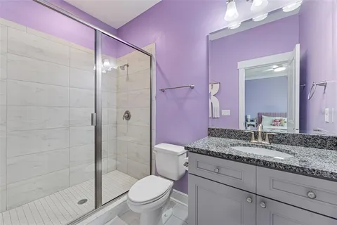 a living room with patio furniture and a potted plant