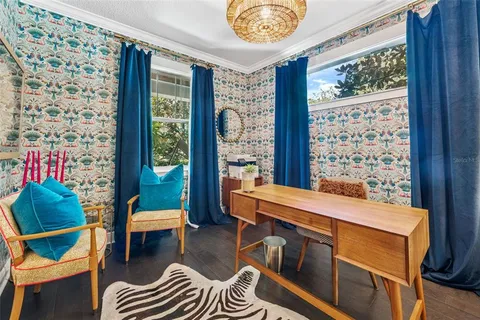 a view of a dining room with furniture a chandelier and wooden floor